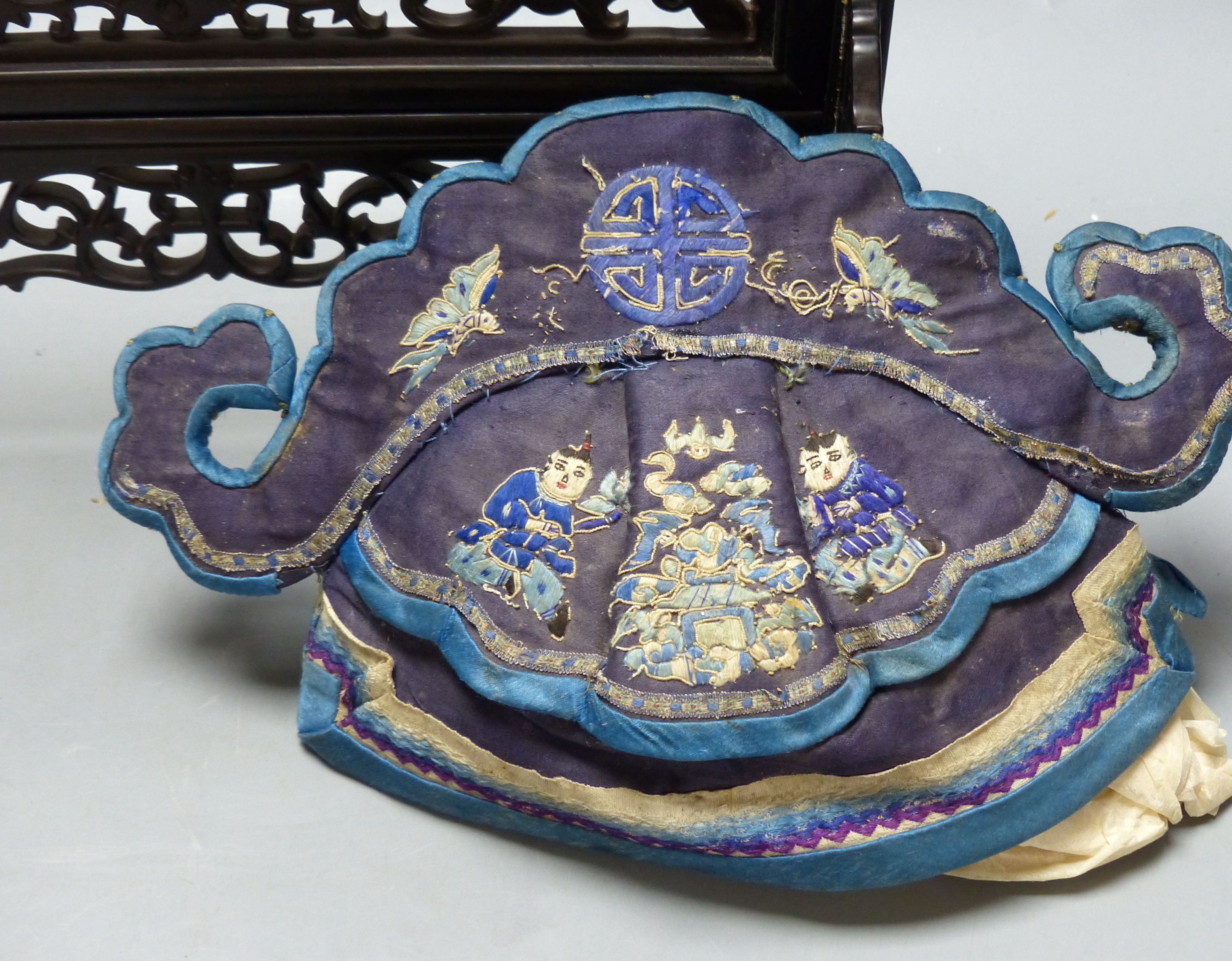 A carved Chinese table stand, 43cm, a mandarin hat and a set of mats